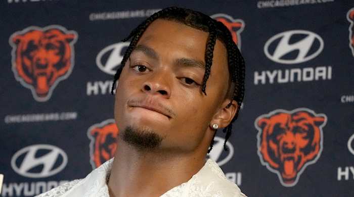 Bears quarterback Justin Fields listens to a question during a news conference after a loss to the Packers.